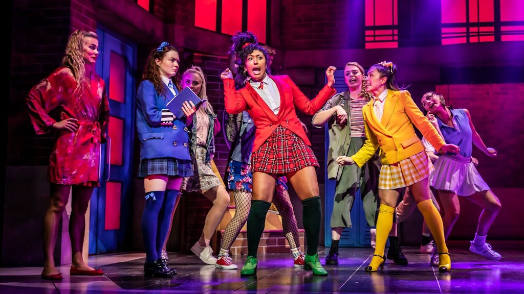 the cast of Heathers onstage, with the four principal characters in the foreground